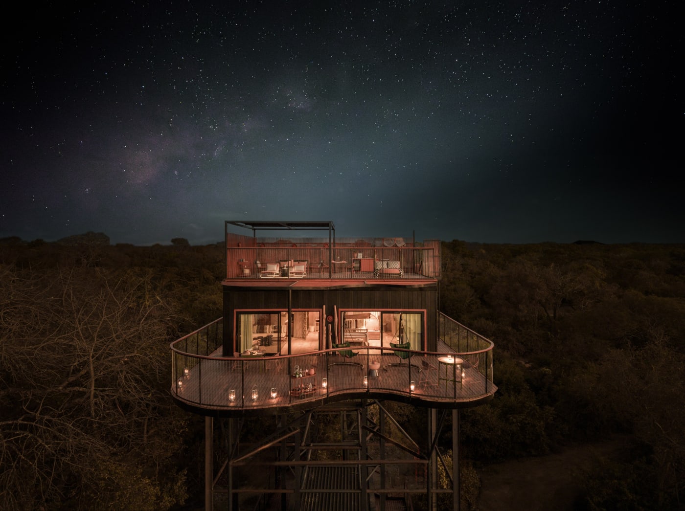 Horizon Terrace Suite at Anantara Tented Camp Kafue River lit up under a starry sky in Kafue National Park