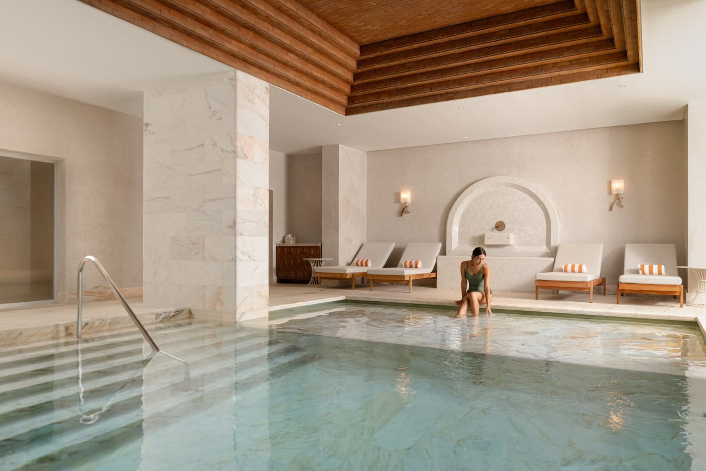 Indoor thermal pool at the Viceroy at Ombria Algarve spa, with wooden ceiling and loungers