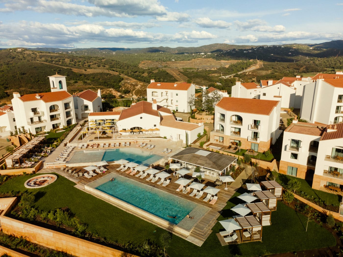 Aerial view of Viceroy at Ombria Algarve, with its white tile-roofed buildings and pool