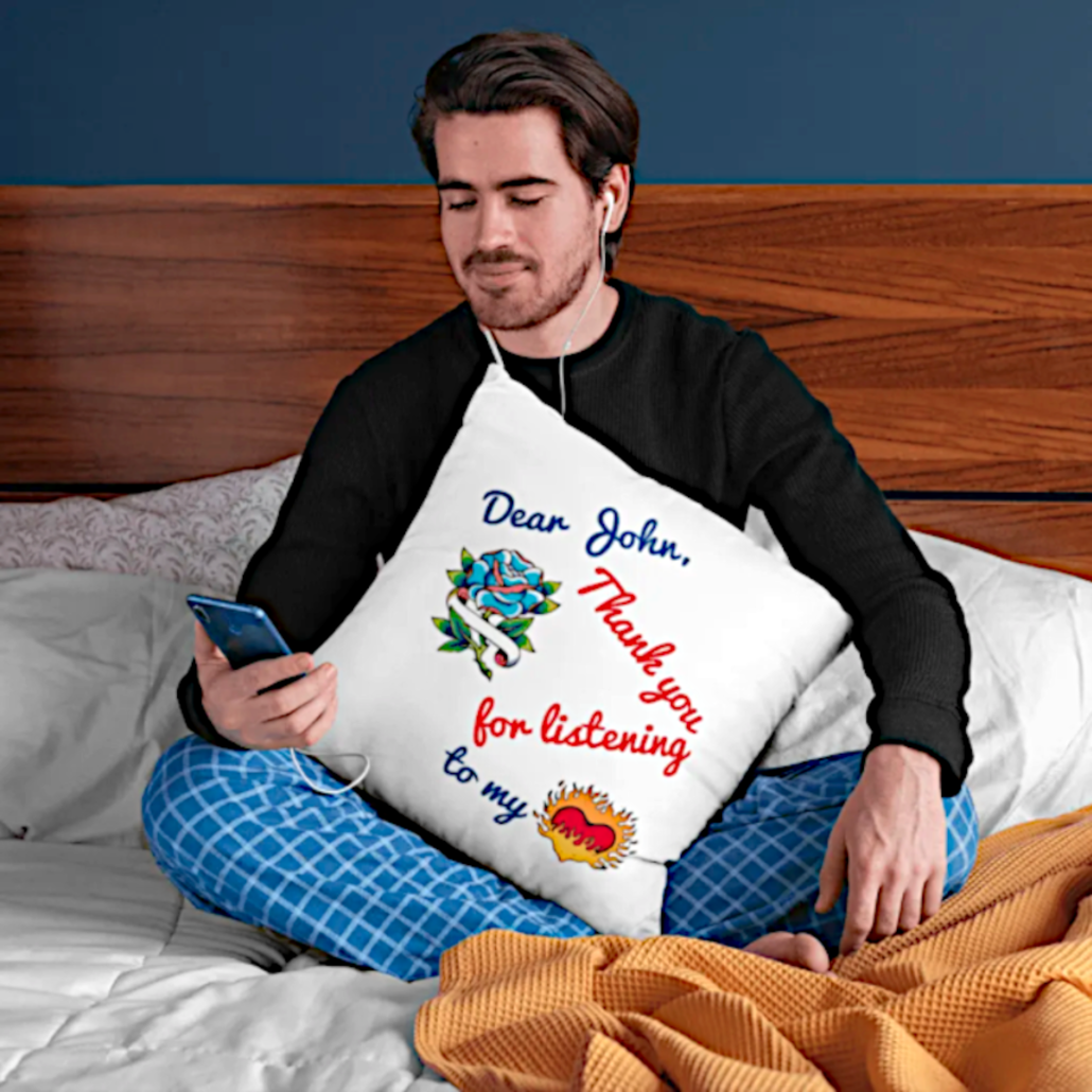 Guy in bed with phone and custom pillowcase