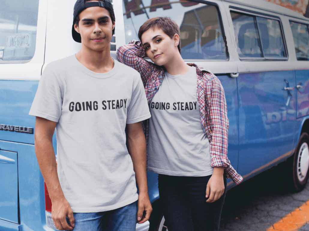 Couple with matching T-shirts and camper van