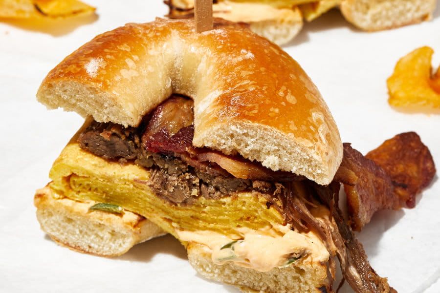 Bagel with bacon, meat, cheese and souce