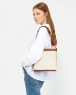 Bolso Hobo efecto rafia con asa bandolera por 14,50€.