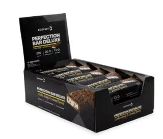 1+1 gratis op een Perfection Bar Deluxe cookie douche & caramel eiwitrepen box bij body en Fit