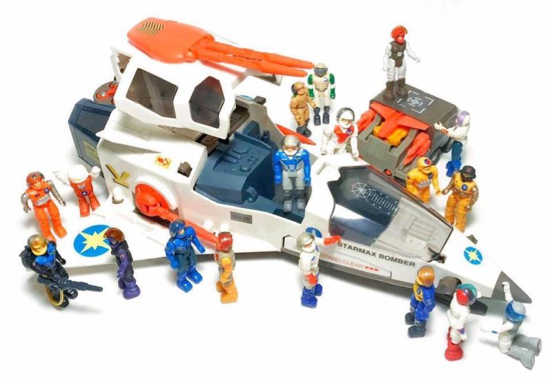 A toy Starcom spaceship surrounded by action figures