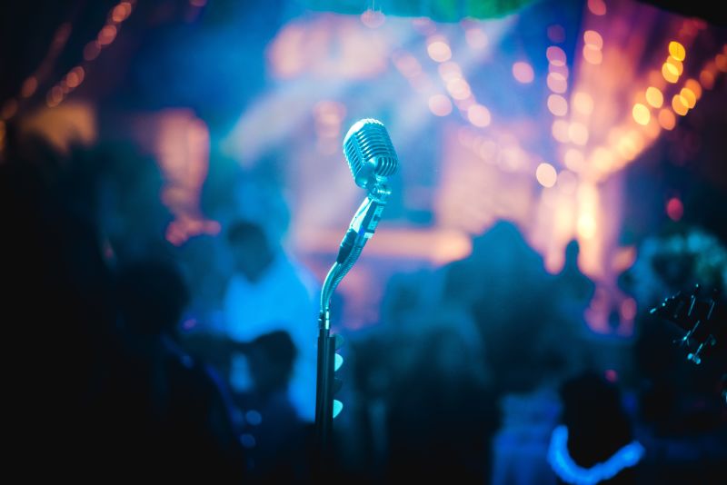 A microphone on a stage in a dimly lit bar