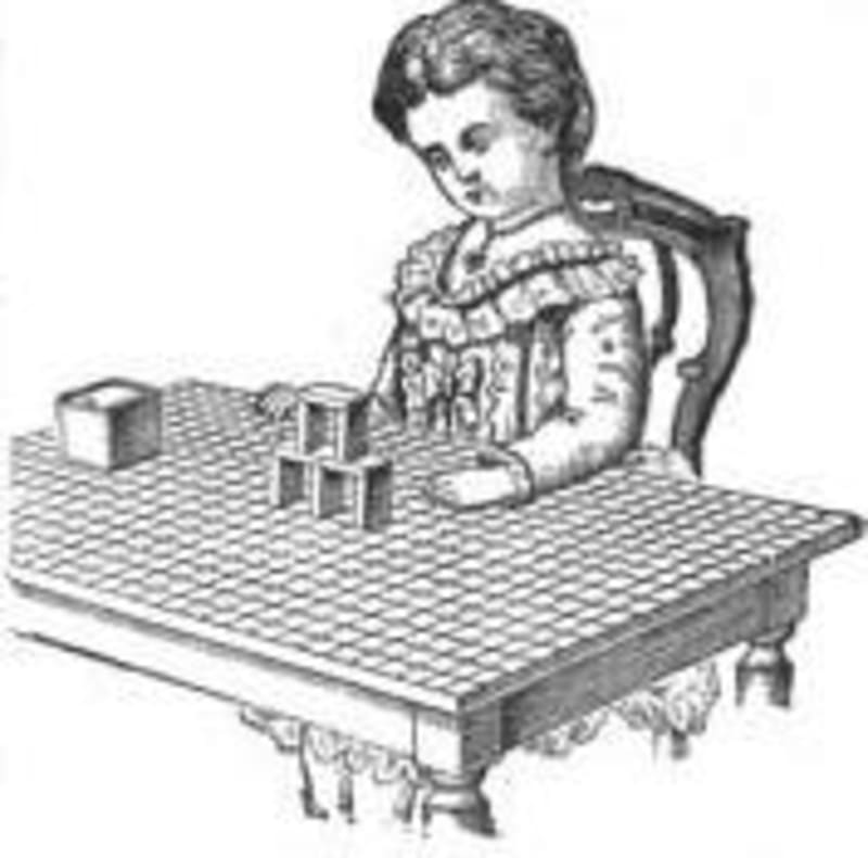 A child playing with Froebel's Gift 4, on a gridded tabletop. Image from Wikipedia