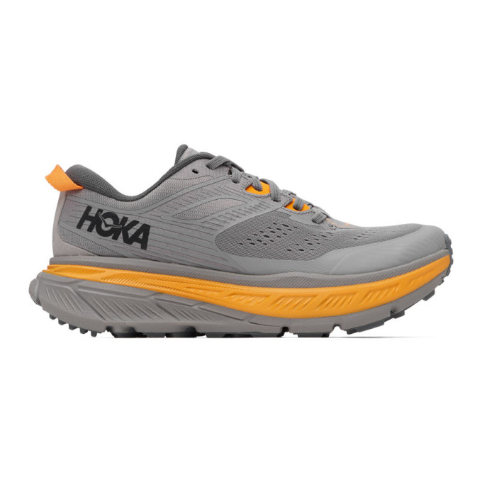 Click to view more detailed imagery on our partner's website Hoka One One Grey Stinson Atr 6 Sneakers In Grey/orange