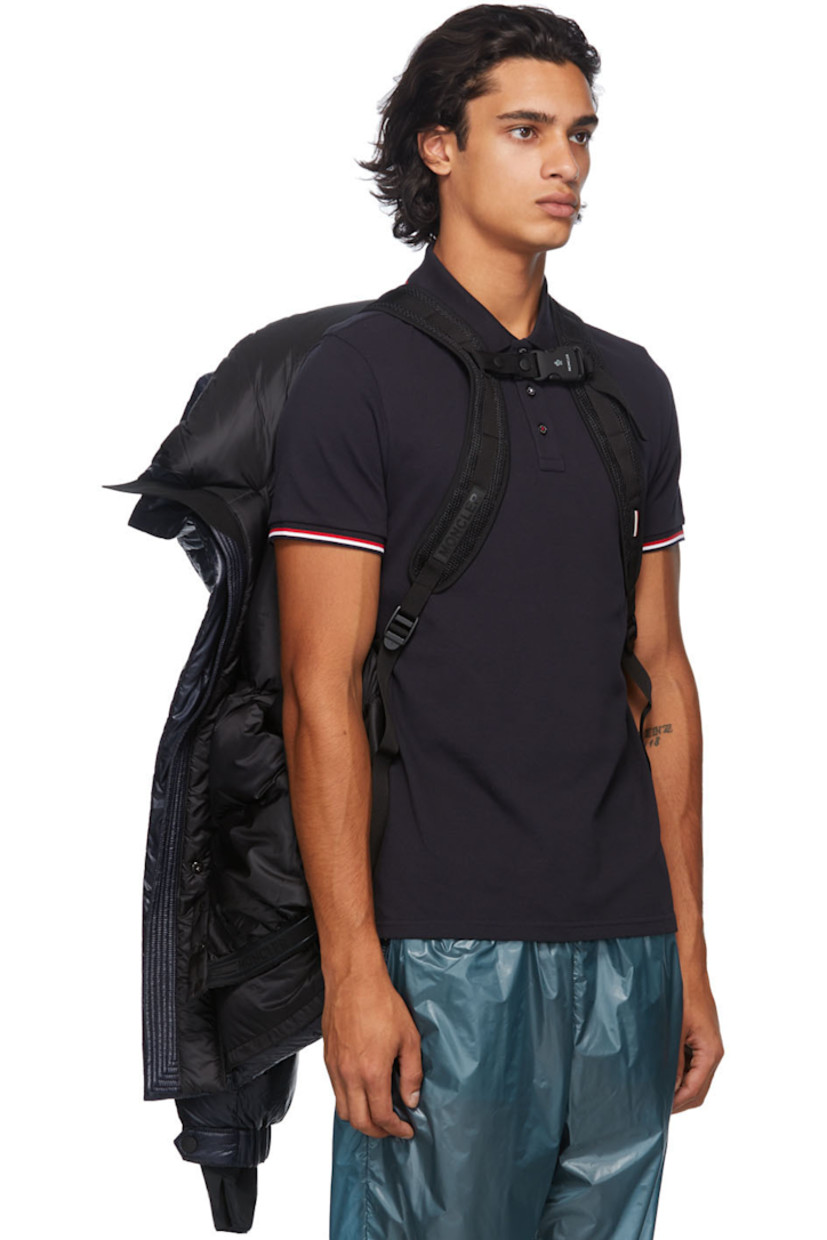 Long sleeve down-filled quilted technical ripstop coat in navy. Bungee-style drawstring at hood. Concealed zip closure with Velcro placket at front. Flap pockets and zippered pockets at waist. Detachable embroidered logo patch in black with Velcro fastening. Adjustable press-stud tab and thumb opening at integrated bonded jersey cuffs. Zippered pocket at interior featuring headphone wire opening. Integrated adjustable harness in black at interior with press-release buckle fastening. 

Supplier color: Blue

Fill: 90% goose down, 10% feathers.