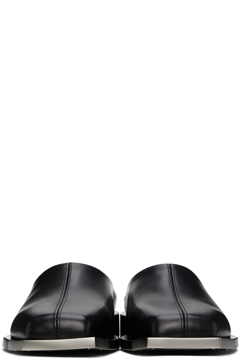 Buffed leather slip-on loafers in black. Metal trim in matte silver-tone at square toe. Logo stamp in silver-tone at black buffed leather footbed. Stacked leather heel. Leather outsole in black. 

Supplier color: Black/Silver