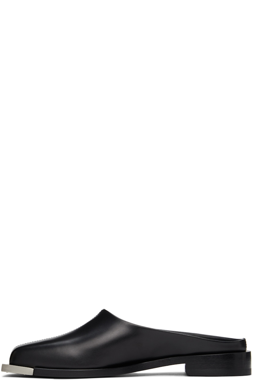 Buffed leather slip-on loafers in black. Metal trim in matte silver-tone at square toe. Logo stamp in silver-tone at black buffed leather footbed. Stacked leather heel. Leather outsole in black. 

Supplier color: Black/Silver