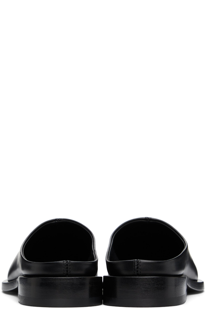 Buffed leather slip-on loafers in black. Metal trim in matte silver-tone at square toe. Logo stamp in silver-tone at black buffed leather footbed. Stacked leather heel. Leather outsole in black. 

Supplier color: Black/Silver