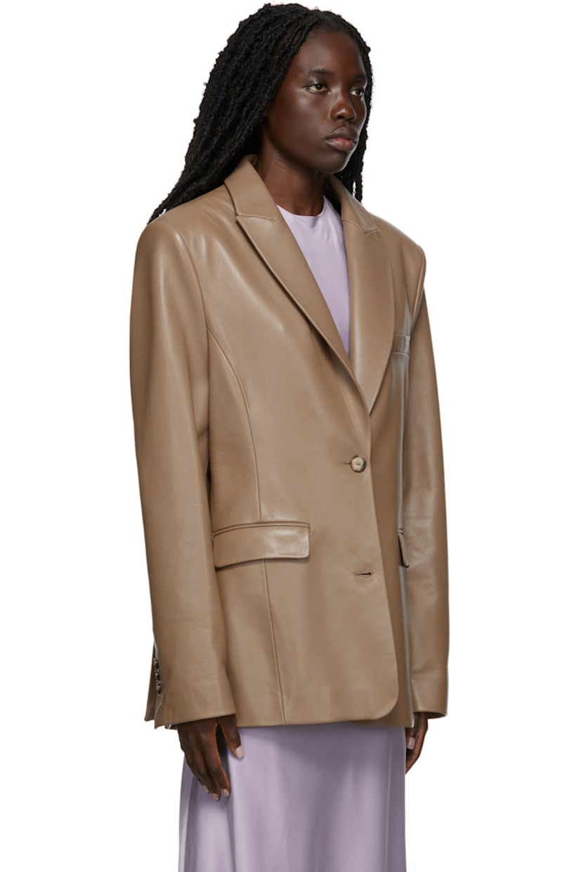 Long sleeve grained lambskin blazer in taupe. 

· Peaked lapel collar
· Two-button closure at front
· Welt pocket at chest
· Flap pockets at waist
· Twin vents at back hem
· Full lining

Supplier color: Taupe