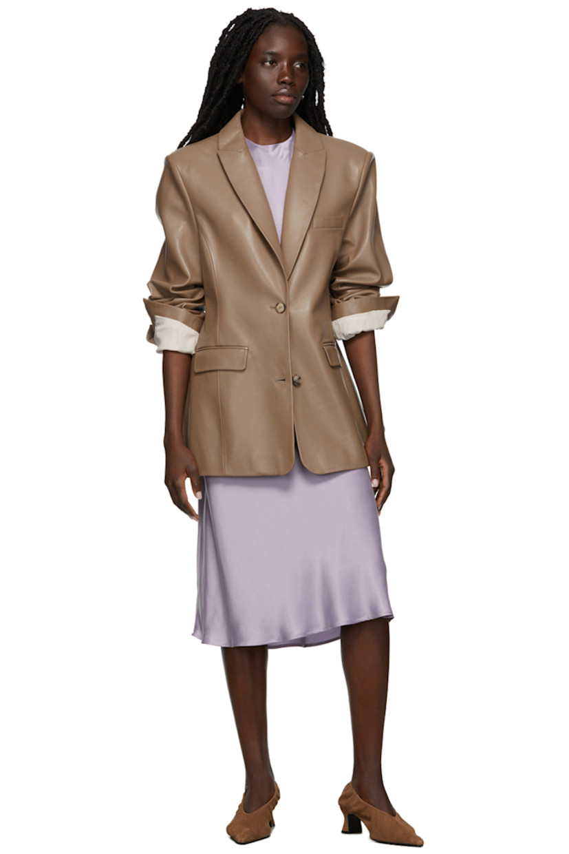 Long sleeve grained lambskin blazer in taupe. 

· Peaked lapel collar
· Two-button closure at front
· Welt pocket at chest
· Flap pockets at waist
· Twin vents at back hem
· Full lining

Supplier color: Taupe