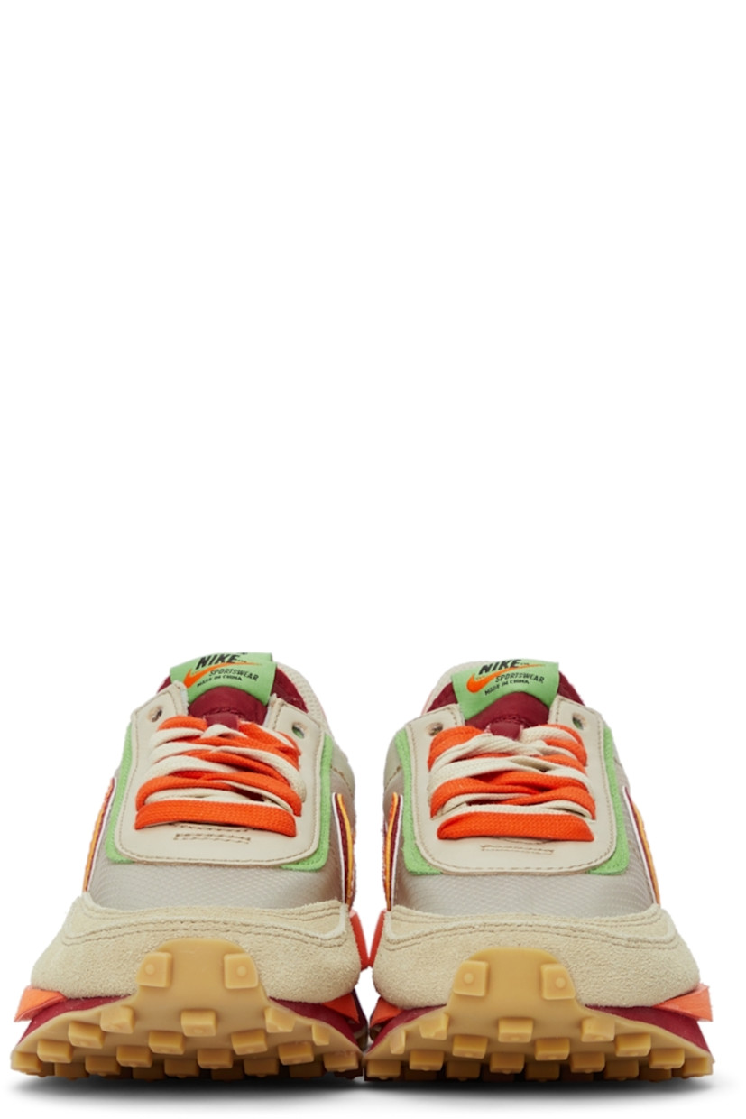 Low-top paneled transparent ripstop and suede sneakers in beige. Round toe. Double lace-up closure in grey and orange featuring buffed leather trim in green at eyerows. Twin padded tongues in orange and red. Padded collar. Signature Swoosh at sides. Logo printed in green at orange buffed leather heel tab. Sculptural foam rubber midsole. Tonal waffle treaded rubber outsole. 

Part of the Nike x sacai x CLOT collaboration. 

Supplier color: Net/Orange blaze