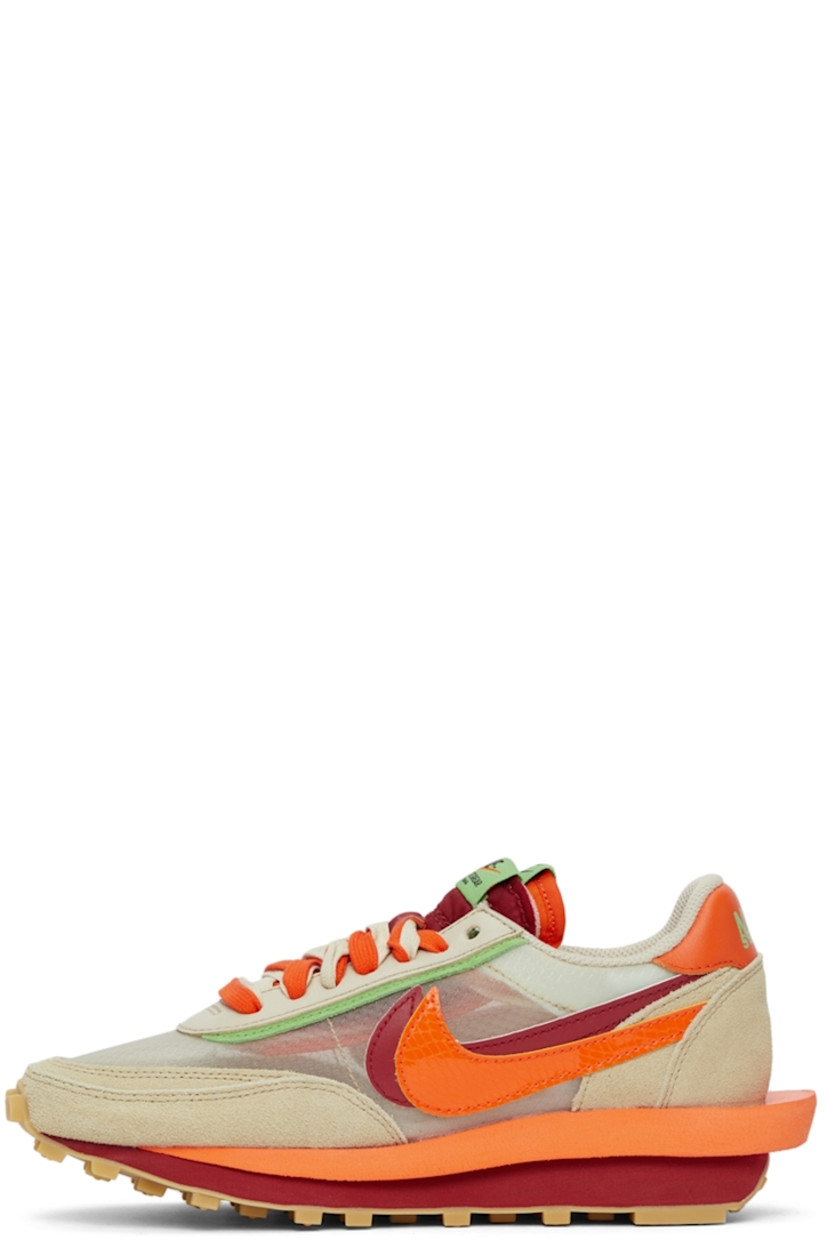 Low-top paneled transparent ripstop and suede sneakers in beige. Round toe. Double lace-up closure in grey and orange featuring buffed leather trim in green at eyerows. Twin padded tongues in orange and red. Padded collar. Signature Swoosh at sides. Logo printed in green at orange buffed leather heel tab. Sculptural foam rubber midsole. Tonal waffle treaded rubber outsole. 

Part of the Nike x sacai x CLOT collaboration. 

Supplier color: Net/Orange blaze