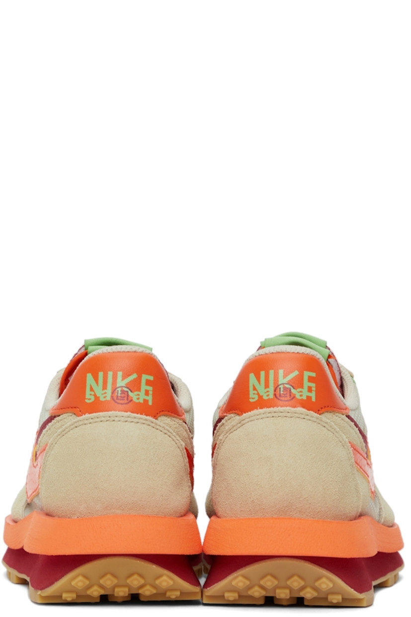 Low-top paneled transparent ripstop and suede sneakers in beige. Round toe. Double lace-up closure in grey and orange featuring buffed leather trim in green at eyerows. Twin padded tongues in orange and red. Padded collar. Signature Swoosh at sides. Logo printed in green at orange buffed leather heel tab. Sculptural foam rubber midsole. Tonal waffle treaded rubber outsole. 

Part of the Nike x sacai x CLOT collaboration. 

Supplier color: Net/Orange blaze