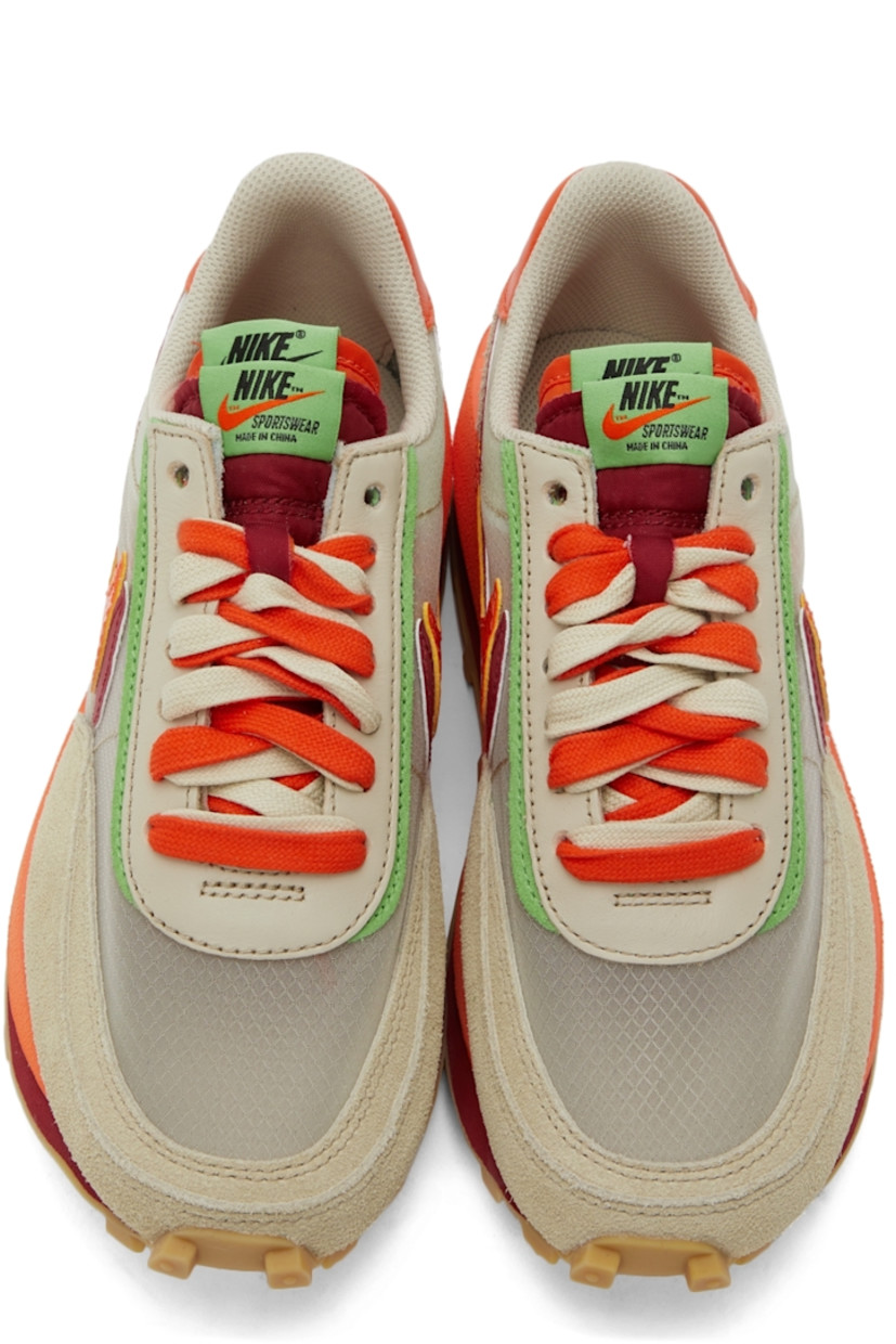 Low-top paneled transparent ripstop and suede sneakers in beige. Round toe. Double lace-up closure in grey and orange featuring buffed leather trim in green at eyerows. Twin padded tongues in orange and red. Padded collar. Signature Swoosh at sides. Logo printed in green at orange buffed leather heel tab. Sculptural foam rubber midsole. Tonal waffle treaded rubber outsole. 

Part of the Nike x sacai x CLOT collaboration. 

Supplier color: Net/Orange blaze