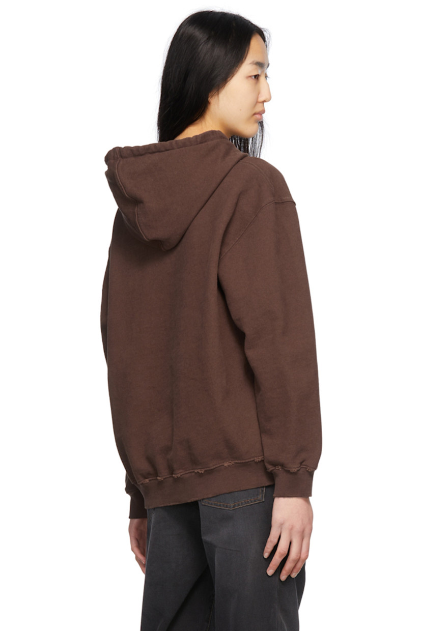 Garment-dyed organic cotton French terry hoodie. Distressing throughout. 

· Drawstring at hood
· Logo graphic embroidered at front
· Dropped shoulders
· Kangaroo pocket
· Rib knit cuffs and hem

Supplier color: Brown