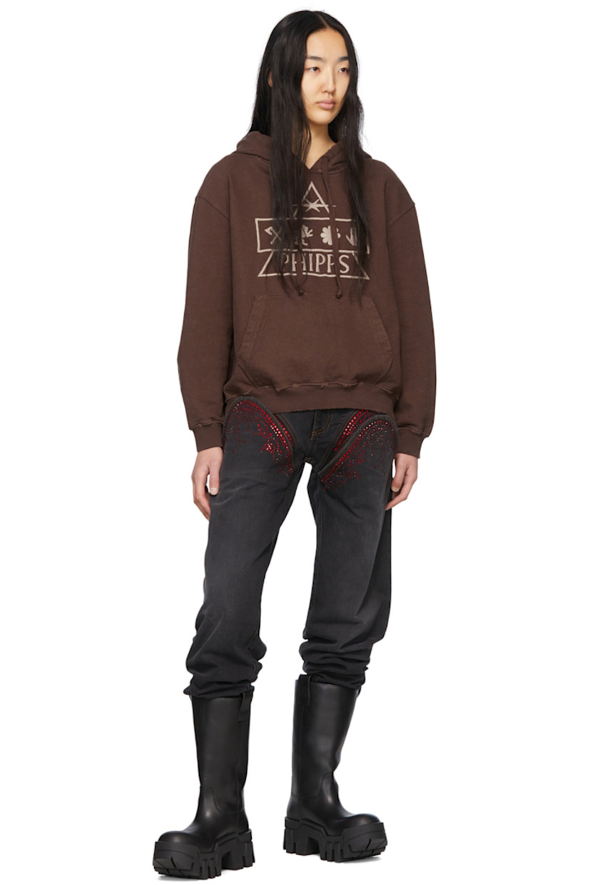Garment-dyed organic cotton French terry hoodie. Distressing throughout. 

· Drawstring at hood
· Logo graphic embroidered at front
· Dropped shoulders
· Kangaroo pocket
· Rib knit cuffs and hem

Supplier color: Brown