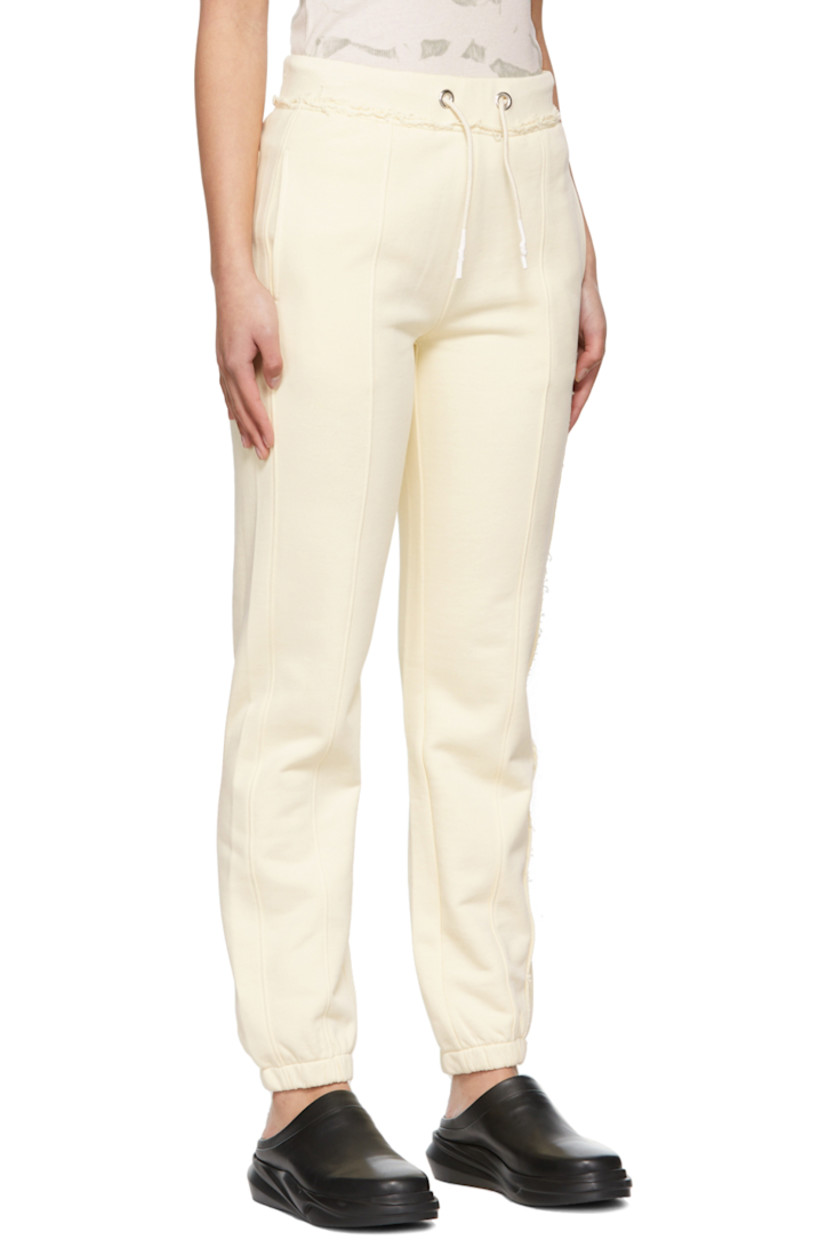 Relaxed-fit French terry lounge pants in off-white. Frayed edges throughout. 

· Mid-rise
· Three-pocket styling
· Drawstring at elasticized waistband
· Tonal logo printed at out-seam
· Elasticized cuffs

Supplier color: Custard