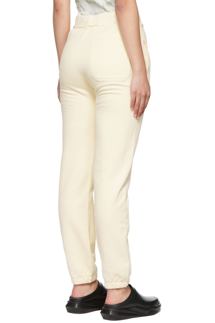 Relaxed-fit French terry lounge pants in off-white. Frayed edges throughout. 

· Mid-rise
· Three-pocket styling
· Drawstring at elasticized waistband
· Tonal logo printed at out-seam
· Elasticized cuffs

Supplier color: Custard