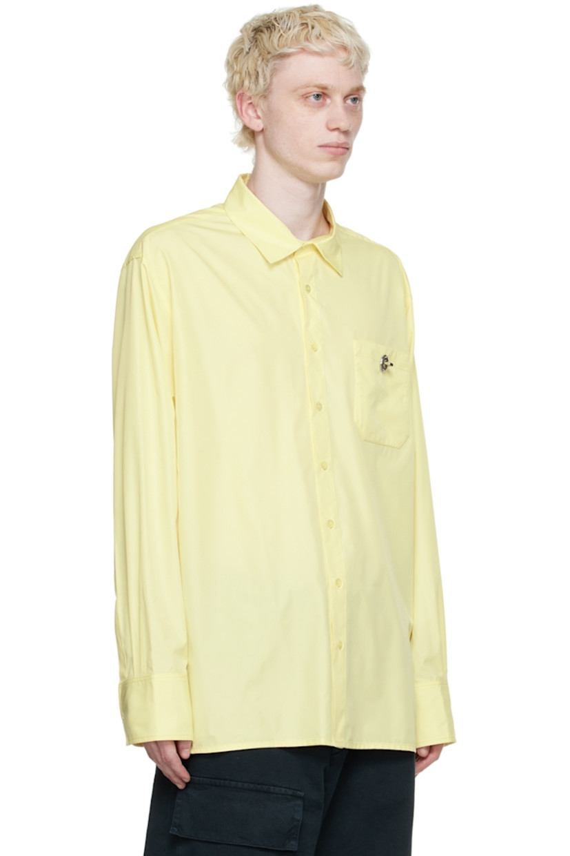 Recycled polyester satin shirt. 

· Spread collar
· Button closure 
· Patch pocket with turn-lock fastening
· Box pleat at back yoke
· Single-button barrel cuffs

Supplier color: Soft yellow parley