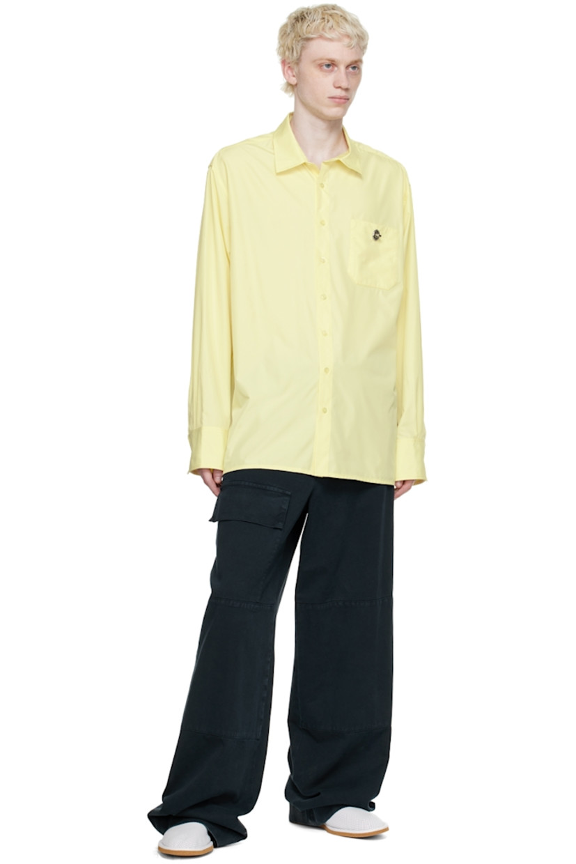 Recycled polyester satin shirt. 

· Spread collar
· Button closure 
· Patch pocket with turn-lock fastening
· Box pleat at back yoke
· Single-button barrel cuffs

Supplier color: Soft yellow parley