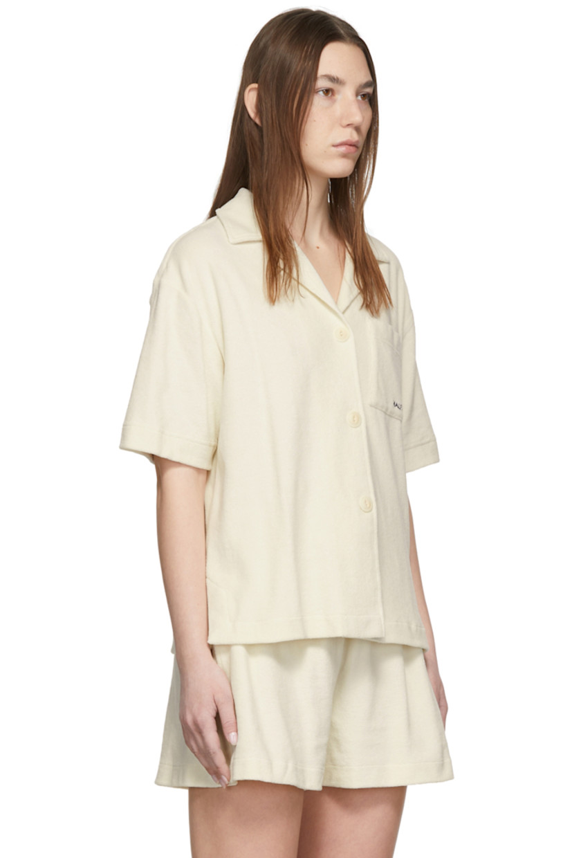 Short sleeve cotton and nylon-blend terrycloth shirt in off-white. Logo embroidered in navy at front. 

· Open spread collar
· Button closure
· Patch pocket at chest
· Vented side-seams

Supplier color: Cream