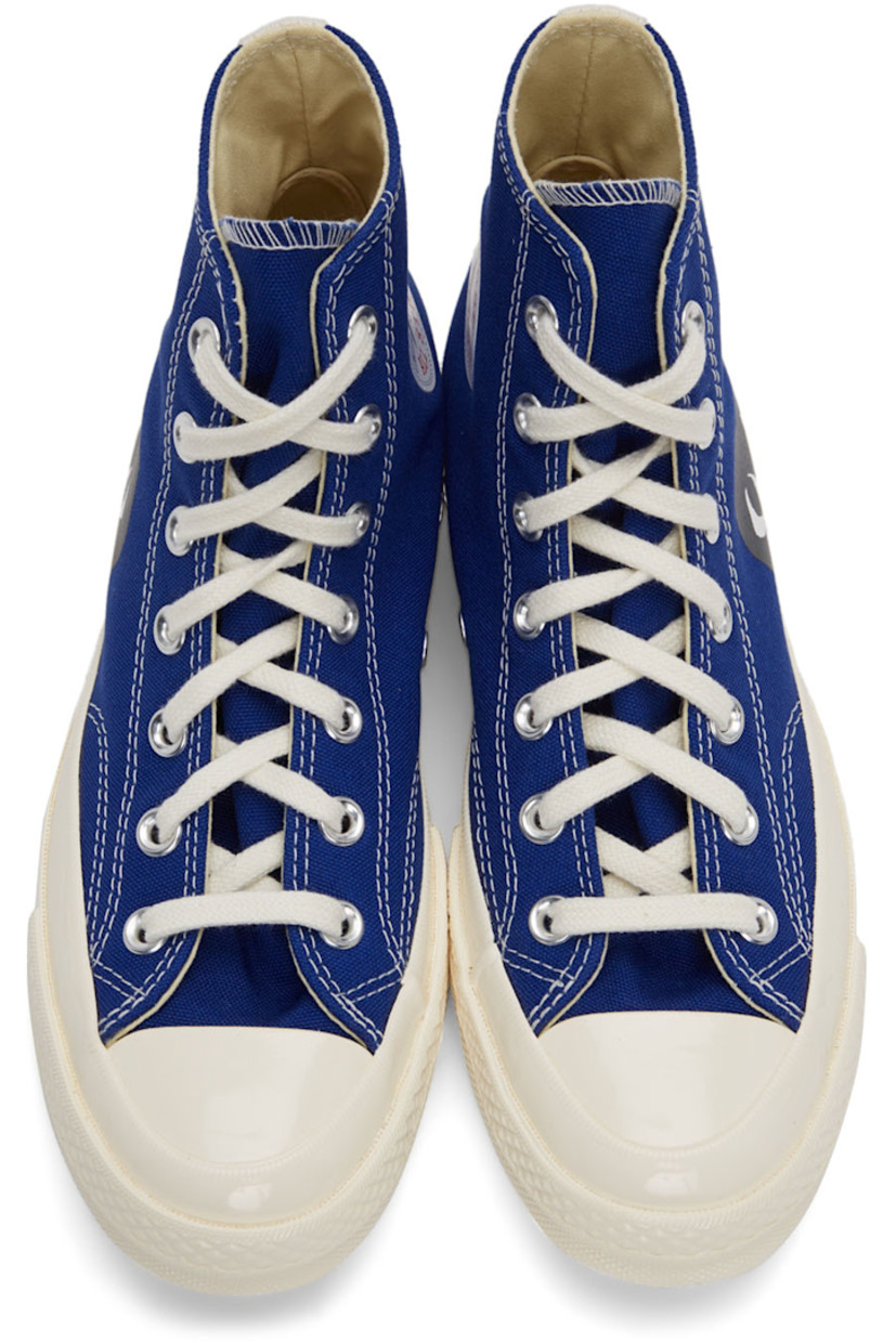 High-top canvas sneakers in blue featuring logo graphic bonded in black at outer side.

· Lace-up closure 
· Webbing trim at heel
· Rubber sole
· Silver-tone hardware

Part of the Comme des Garçons Play x Converse collaboration.

Supplier color: Blue quartz/Egret/Black