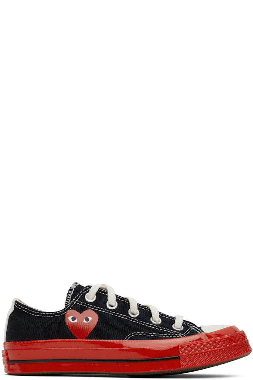 Low-top canvas sneakers in black. 

· Round rubber cap toe
· Lace-up closure
· Logo graphic printed at outer side
· Eyelet vents at inner side
· Webbing trim in white at heel
· Rubber midsole in red featuring
· Logo embossed at heel 
· Treaded rubber outsole in brown
· Contrast stitching in white

Part of the Comme des Garçons Play x Converse collaboration.

Supplier color: Black
