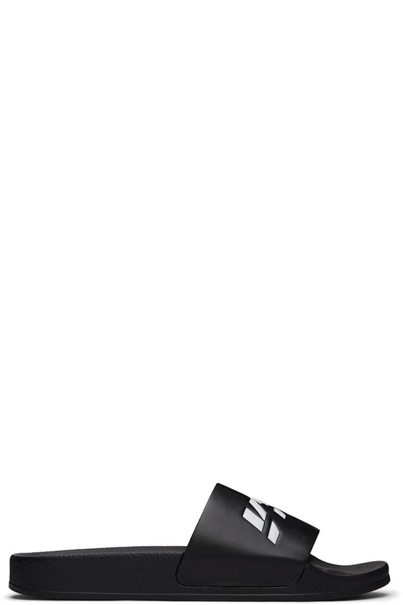 TPU slip-on sandals in black. Logo embossed in white at vamp.

· Logo graphic printed at molded rubber footbed 
· Rubber sole

Supplier color: Black/White