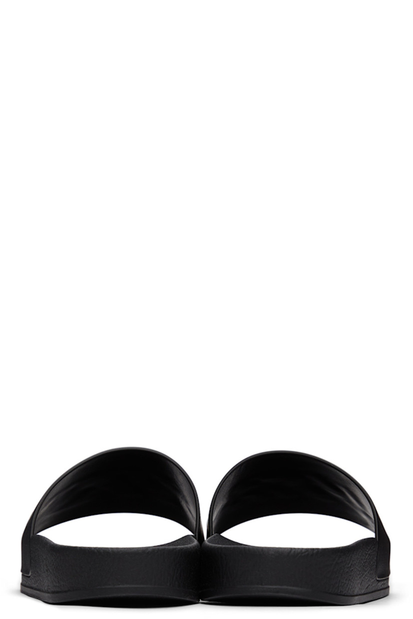 TPU slip-on sandals in black. Logo embossed in white at vamp.

· Logo graphic printed at molded rubber footbed 
· Rubber sole

Supplier color: Black/White