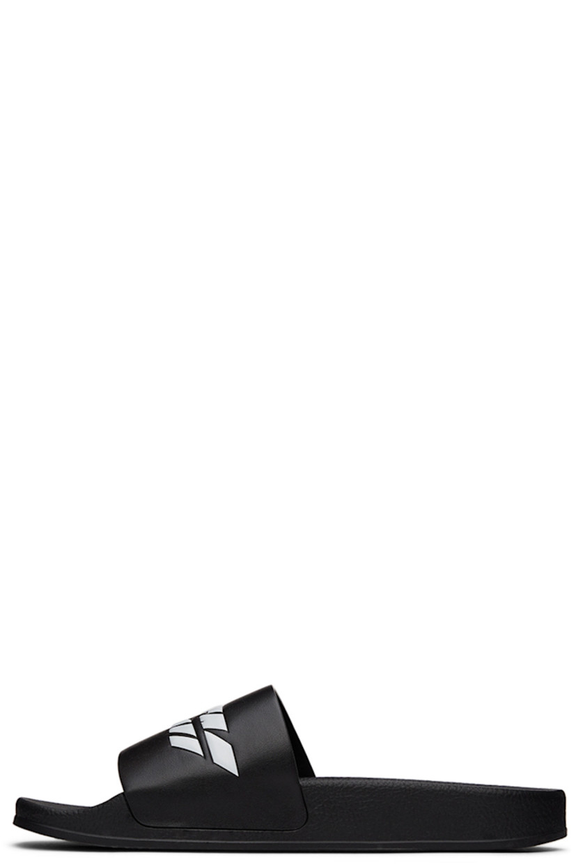 TPU slip-on sandals in black. Logo embossed in white at vamp.

· Logo graphic printed at molded rubber footbed 
· Rubber sole

Supplier color: Black/White