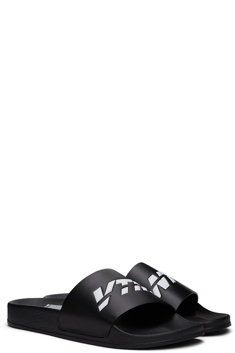 TPU slip-on sandals in black. Logo embossed in white at vamp.

· Logo graphic printed at molded rubber footbed 
· Rubber sole

Supplier color: Black/White