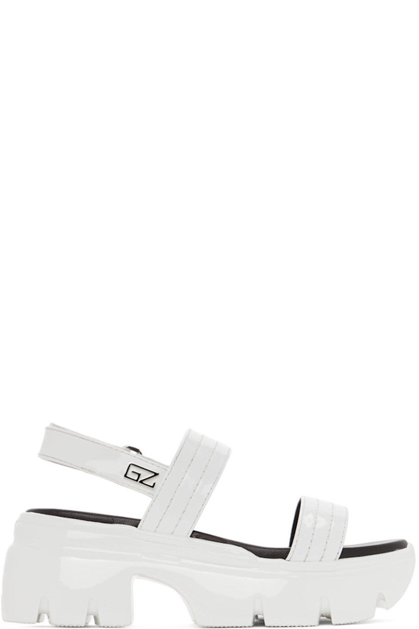 Patent leather sandals in white. Tonal topstitching at vamp.

· Logo embossed at open round toe
· Velcro slingback strap with logo hardware at outer side
· Silver-tone logo stamp at black leather footbed
· Platform rubber midsole
· Treaded rubber outsole
· Heel: H3 in 
· Platform: H2 in 

Supplier color: White