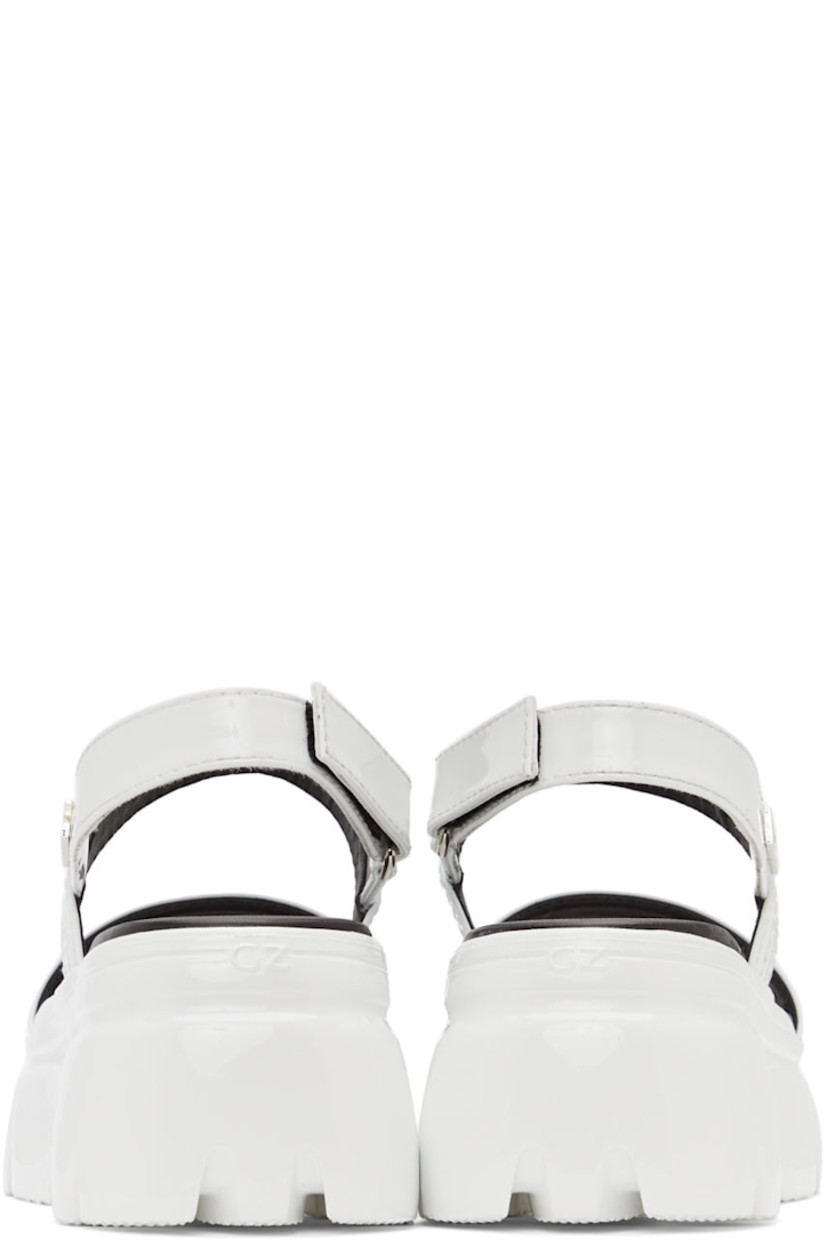 Patent leather sandals in white. Tonal topstitching at vamp.

· Logo embossed at open round toe
· Velcro slingback strap with logo hardware at outer side
· Silver-tone logo stamp at black leather footbed
· Platform rubber midsole
· Treaded rubber outsole
· Heel: H3 in 
· Platform: H2 in 

Supplier color: White