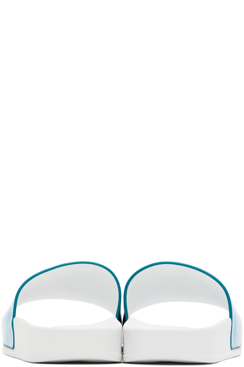 Iridescent textile slip-on sandals in blue.

· Open round toe
· Strap with logo hardware at vamp
· Logo embossed at textured rubber footbed
· Buffed leather lining
· Treaded rubber sole in white

Supplier color: Turquoise