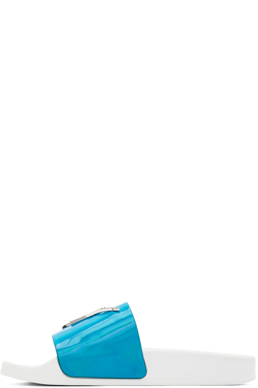 Iridescent textile slip-on sandals in blue.

· Open round toe
· Strap with logo hardware at vamp
· Logo embossed at textured rubber footbed
· Buffed leather lining
· Treaded rubber sole in white

Supplier color: Turquoise