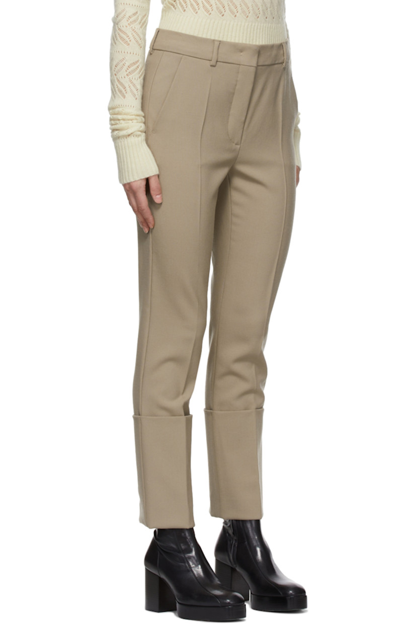 Straight-leg plain woven wool trousers in beige.

· Mid-rise
· Four-pocket styling
· Belt loops at waistband
· Cuffed hem

Supplier color: Dry everblack