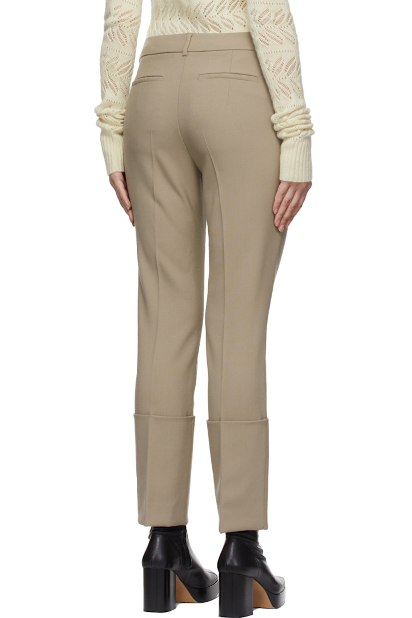 Straight-leg plain woven wool trousers in beige.

· Mid-rise
· Four-pocket styling
· Belt loops at waistband
· Cuffed hem

Supplier color: Dry everblack