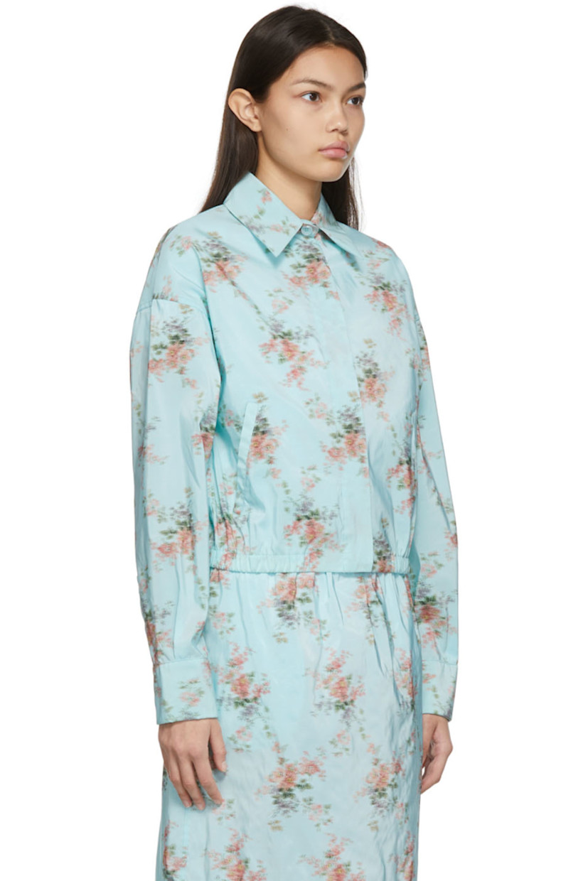 Long sleeve nylon-blend taffeta shirt in blue featuring floral pattern in multicolor. 

· Spread collar
· Concealed button closure
· Pockets at waist
· Two-button barrel cuffs
· Signature crystal-cut detailing at cuff
· Gathering at elasticized hem
· Pleats at back yoke
· Mother-of-pearl hardware

Supplier color: Light blue