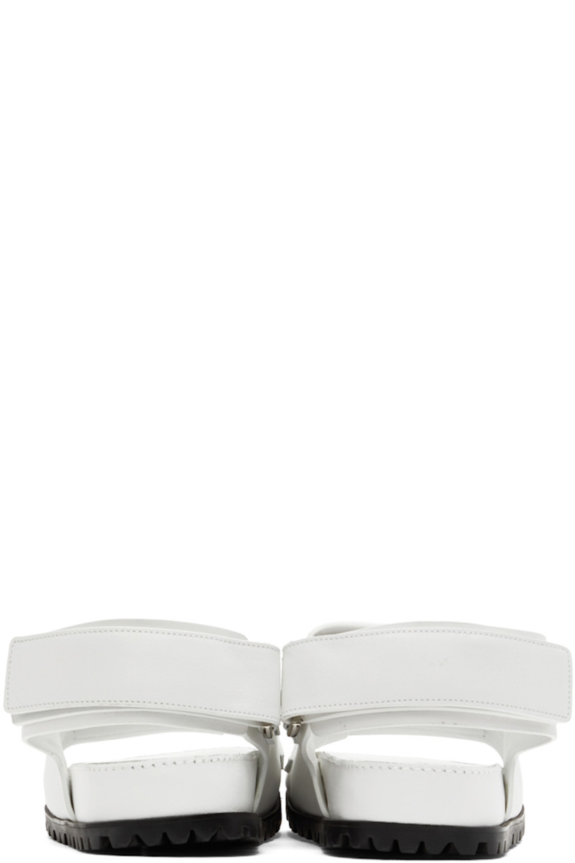 Buffed leather sandals in white. 

· Open round toe
· Velcro straps and logo hardware at vamp
· Velcro slingback strap
· Logo-embossed leather patch at molded leather footbed
· Treaded rubber sole

Supplier color: White