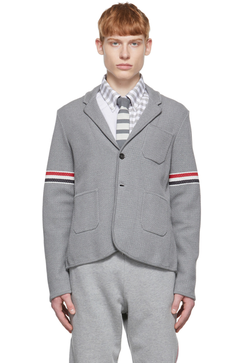 Long sleeve stretch textured knit cotton and wool-blend blazer in grey.

· Notched lapel collar
· Two-button closure at front
· Patch pockets at chest and waist
· Jacquard knit signature tricolor stripes at sleeve
· Four-button surgeon's cuffs with signature tricolor grosgrain trim
· Signature tricolor grosgrain flag at back collar
· Twin vents at back hem
· Detachable signature tricolor grosgrain strap at interior

Supplier color: Light grey