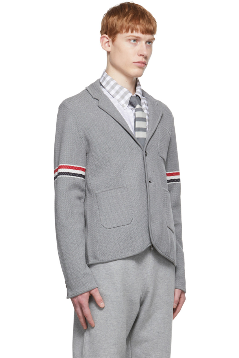 Long sleeve stretch textured knit cotton and wool-blend blazer in grey.

· Notched lapel collar
· Two-button closure at front
· Patch pockets at chest and waist
· Jacquard knit signature tricolor stripes at sleeve
· Four-button surgeon's cuffs with signature tricolor grosgrain trim
· Signature tricolor grosgrain flag at back collar
· Twin vents at back hem
· Detachable signature tricolor grosgrain strap at interior

Supplier color: Light grey