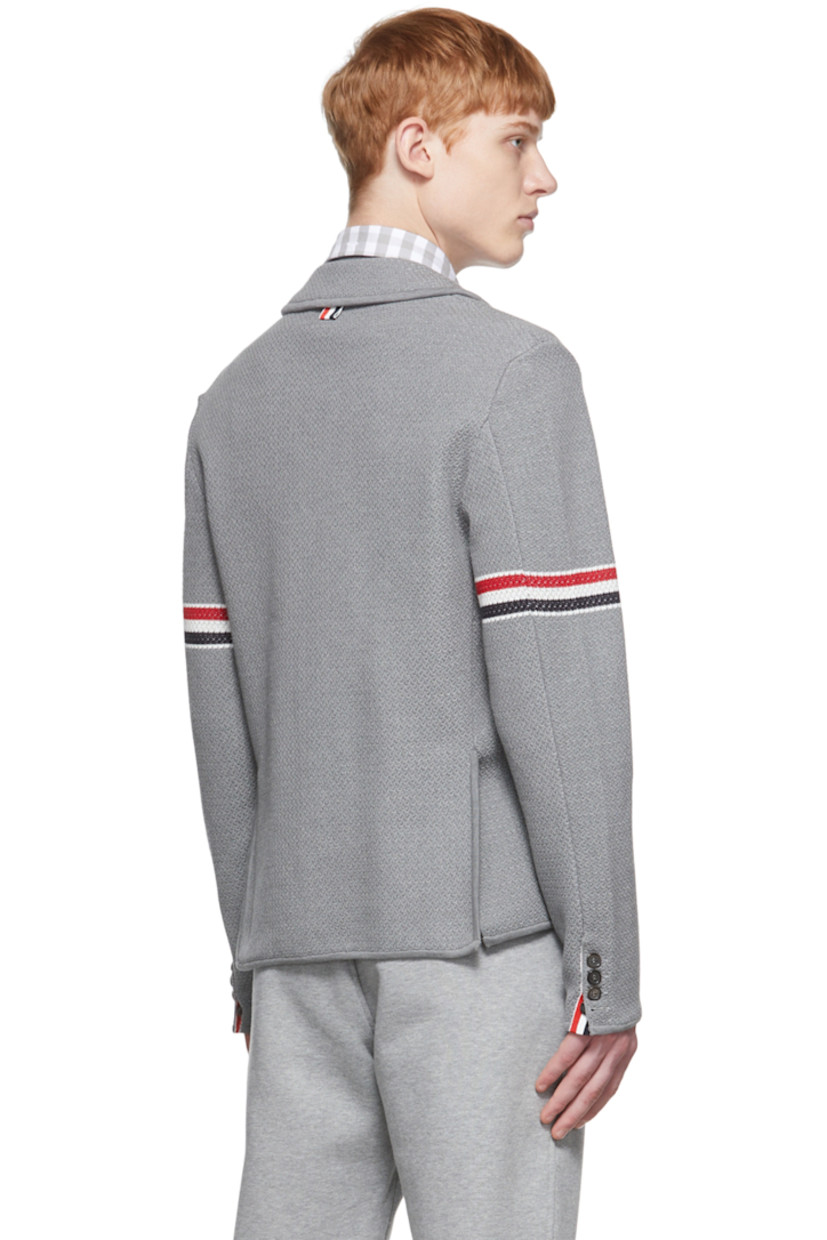 Long sleeve stretch textured knit cotton and wool-blend blazer in grey.

· Notched lapel collar
· Two-button closure at front
· Patch pockets at chest and waist
· Jacquard knit signature tricolor stripes at sleeve
· Four-button surgeon's cuffs with signature tricolor grosgrain trim
· Signature tricolor grosgrain flag at back collar
· Twin vents at back hem
· Detachable signature tricolor grosgrain strap at interior

Supplier color: Light grey