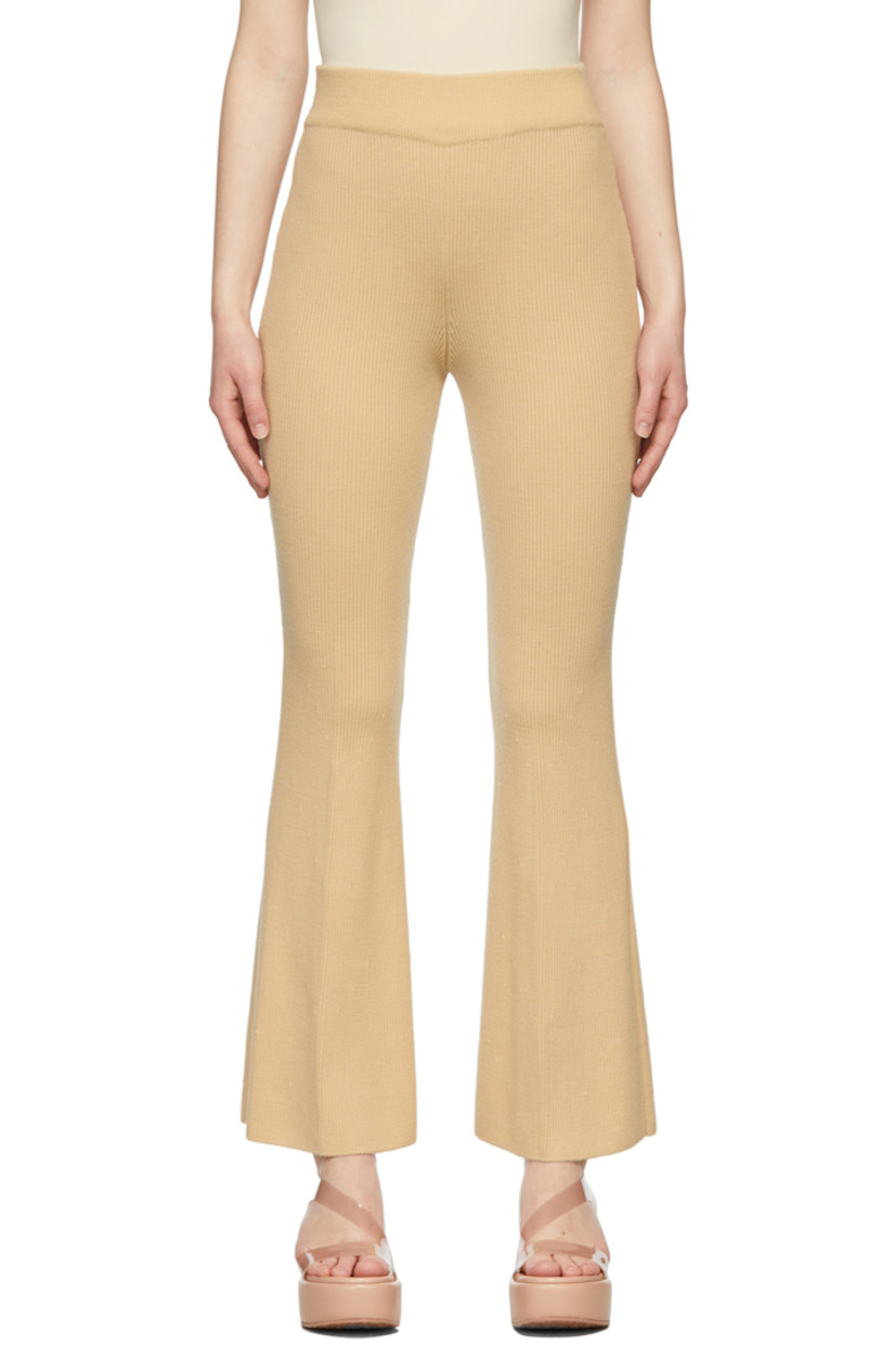 Flared rib knit wool pants in beige. 

· High-rise 
· Elasticized waistband 

Supplier color: Yellow beige