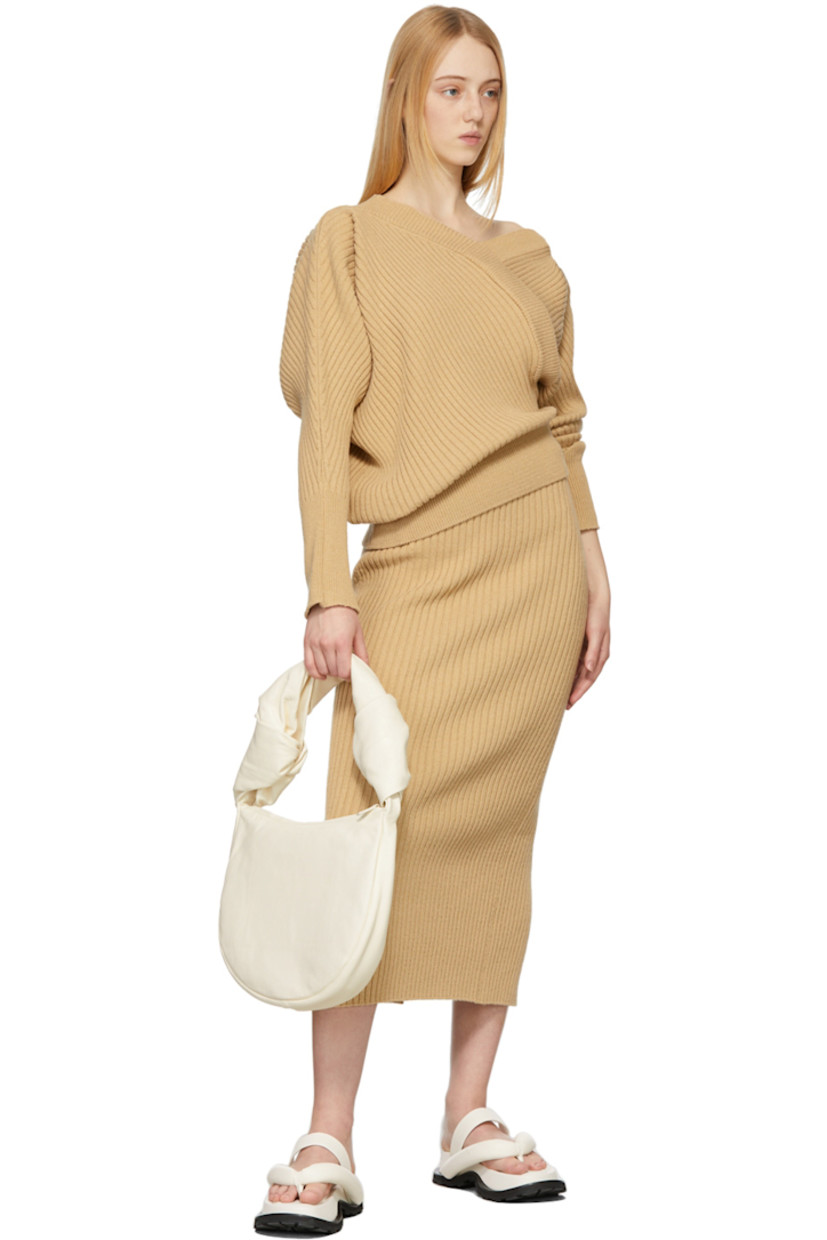 Rib knit cotton-blend skirt in beige. 

· Mid-rise 
· Elasticized waistband
· Central vent at back hem

Supplier color: Beige