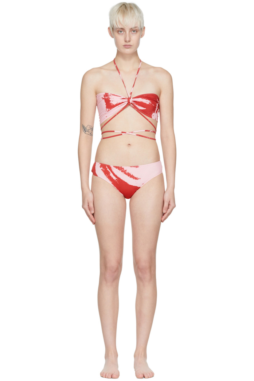 Stretch polyester jersey bikini top. Graphic pattern printed throughout.

· Self-tie halter strap 
· Ruching at front
· Wraparound self-tie straps

Stretch polyester jersey bikini bottoms. Graphic pattern printed throughout.

· Elasticized waistband
· Partially lined

Supplier color: Red pink