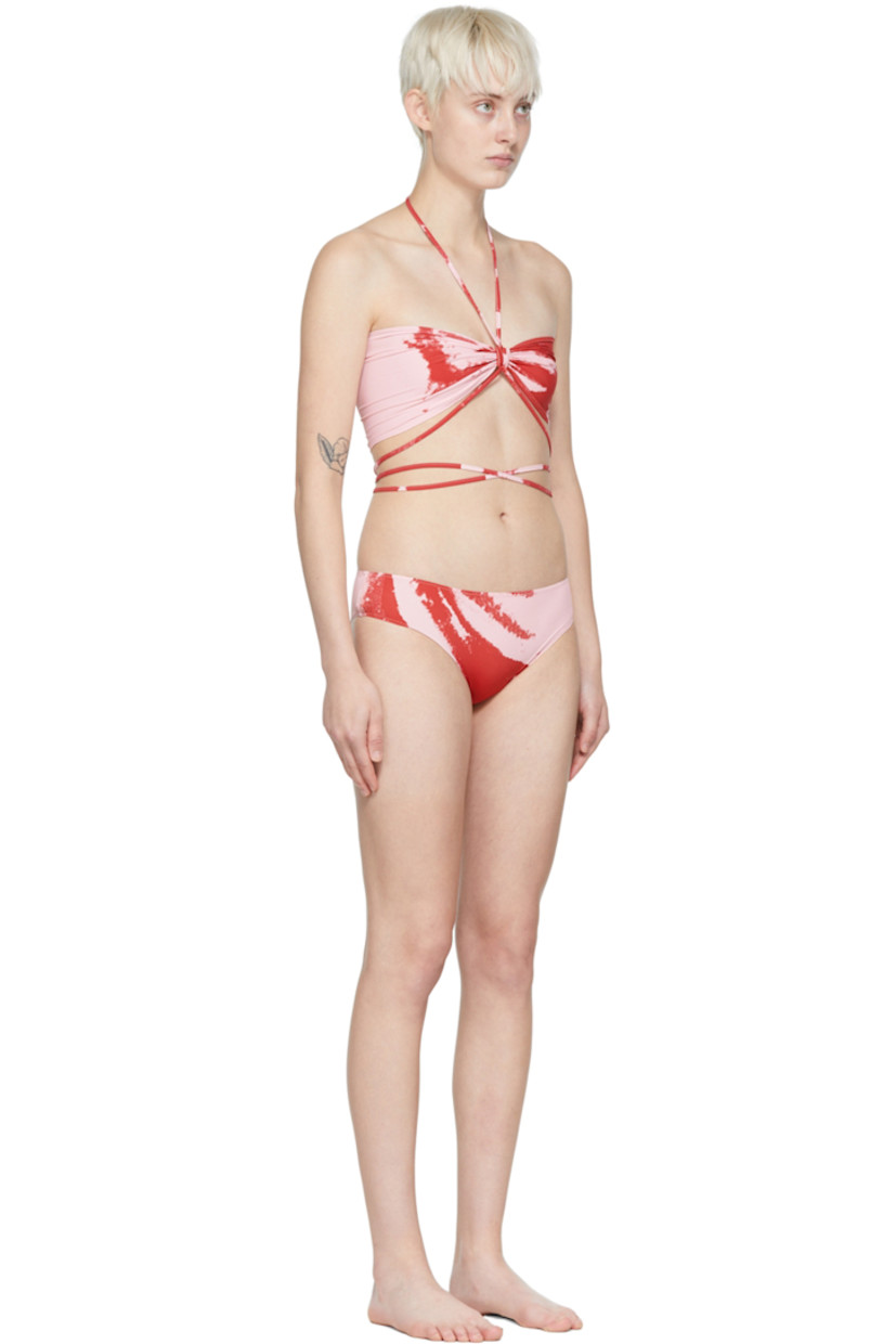 Stretch polyester jersey bikini top. Graphic pattern printed throughout.

· Self-tie halter strap 
· Ruching at front
· Wraparound self-tie straps

Stretch polyester jersey bikini bottoms. Graphic pattern printed throughout.

· Elasticized waistband
· Partially lined

Supplier color: Red pink